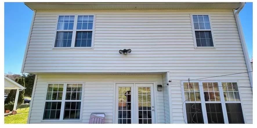 Freshly soft-washed white vinyl siding, streak-free